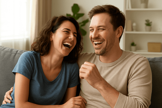 A joyful couple sharing a hearty laugh on a couch, capturing the essence of humor in marriage.