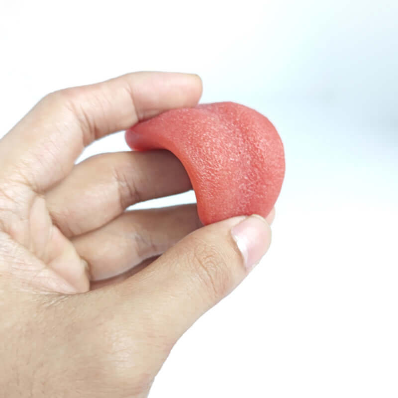 Hand holding a realistic fake tongue prank toy, perfect for Halloween fun and party gags.